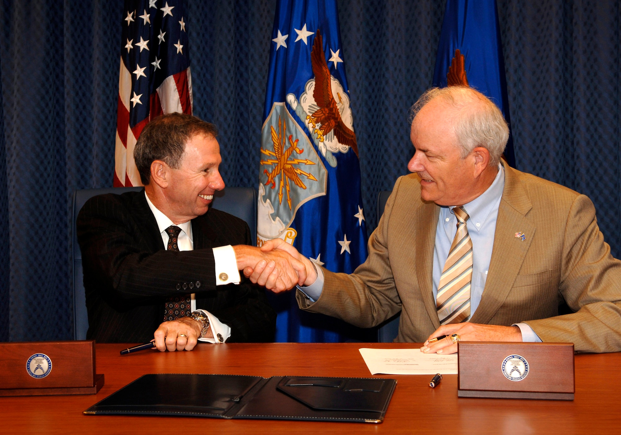 NASA Administrator Michael Griffin (left) and Secretary of the Air Force Michael W. Wynne shake hands after signing a memorandum of understanding Aug. 7 at a Pentagon ceremony. The agreement builds upon and expands on the longstanding relationship between the two organizations. (NASA photo/Bill Ingalls)