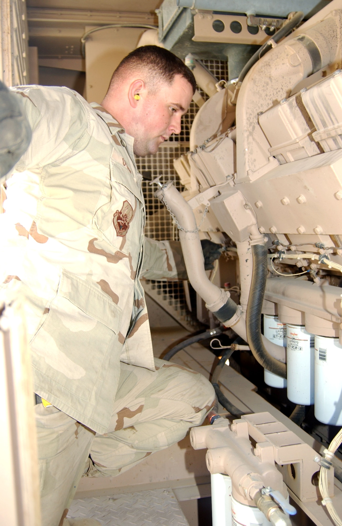 Staff Sgt. Kristopher Oyen checks one of the four generators that supply electricity to housing areas at Balad Air Base, Iraq. He is assigned to the 332nd Air Expeditionary Civil Engineer Squadron. (U.S. Air Force photo/Senior Airman Kerry Solan-Johnson) 