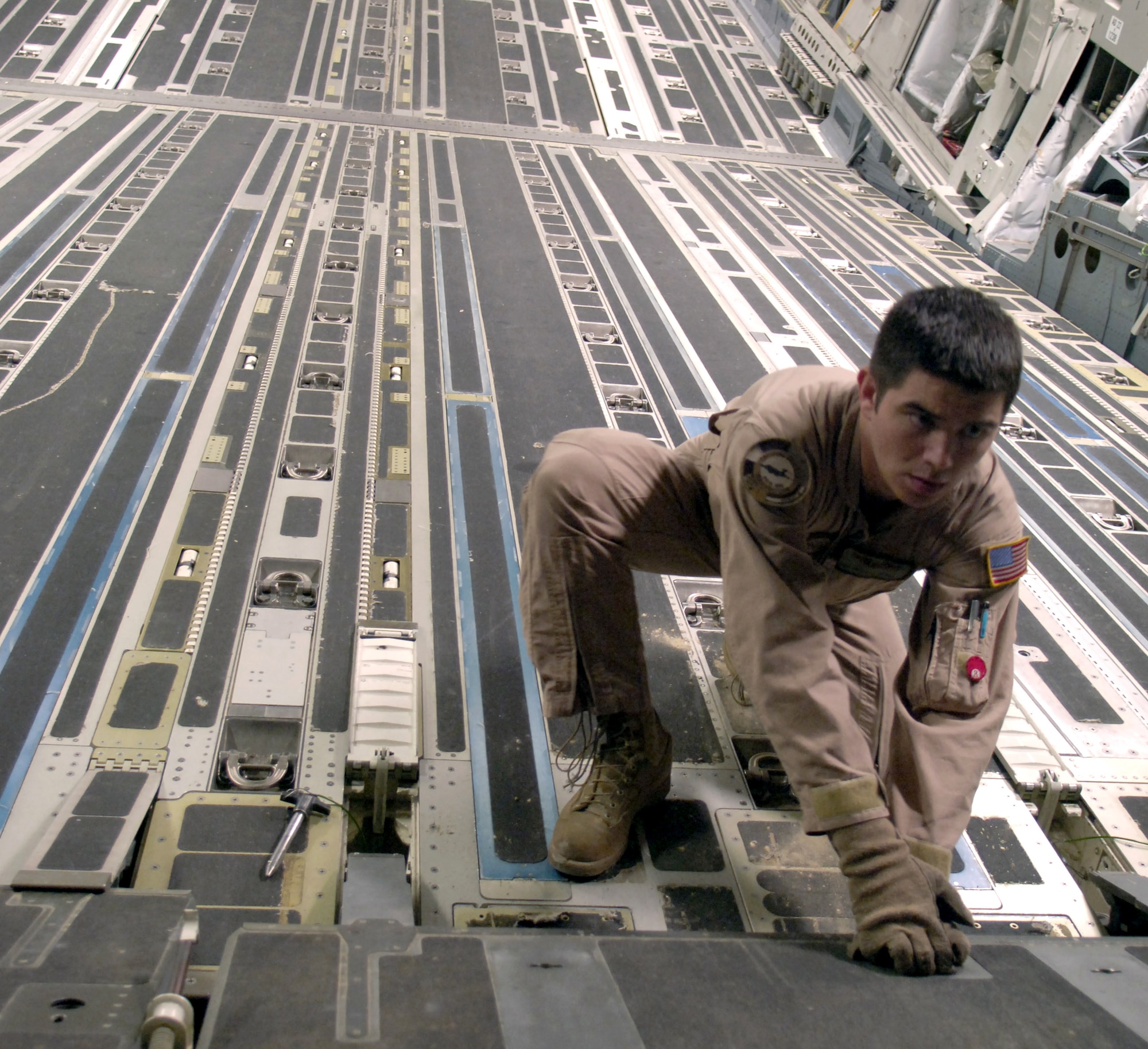 Senior Airman Charles Reimer III configures the ramp of a C-17 Globemaster III before cargo is loaded at a forward operating location in Southwest Asia on Aug. 5. Airman Reimer is a loadmaster with the 816th Expeditionary Airlift Squadron. The squadron is instrumental in the war on terrorism, delivering cargo and troops in support of operations Iraqi Freedom and Enduring Freedom. (U.S. Air Force photo/Senior Airman Brian Ferguson) 
