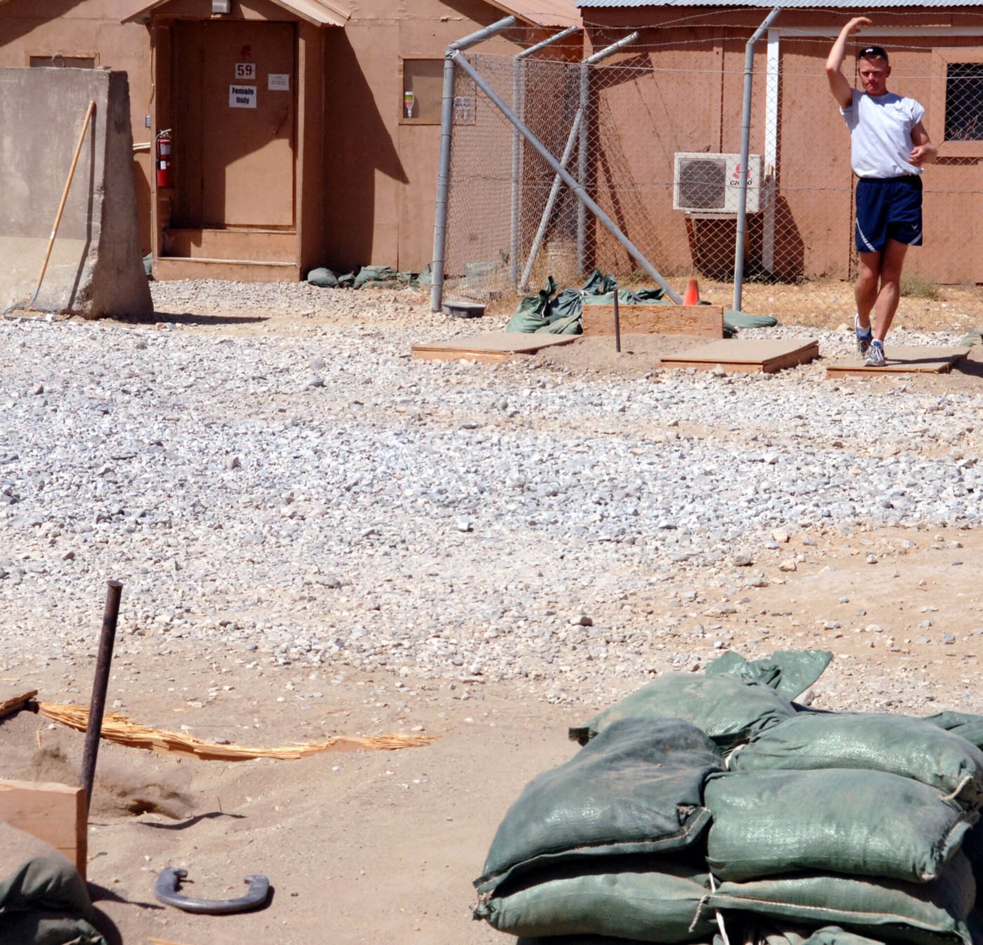 Maj. William Conley throws a horse shoe during Sports Day here. The major's 455th Expeditionary Mission Support Squadron team placed second.  First place in horse shoes went to the 455th Logistics Readiness Squadron. (U.S. Air Force photo by Master Sgt. Orville F. Desjarlais Jr.) 
