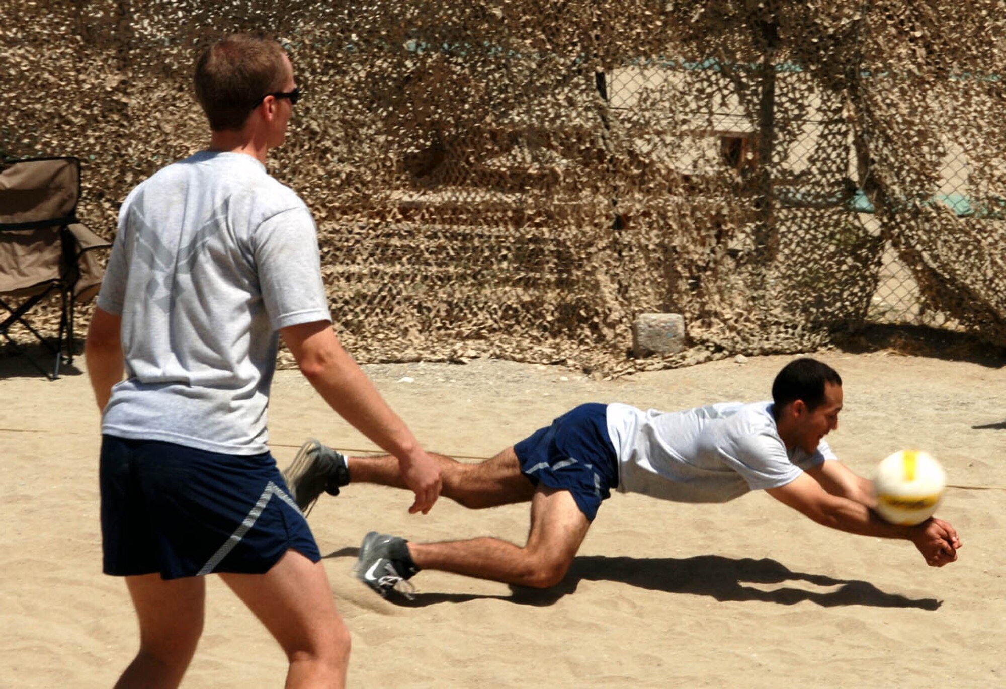 A volleyball player dives for a ball during Sports Day here. The 455th Expeditionary Maintenance Squadron won first place in volleyball. (U.S. Air Force photo by Master Sgt. Orville F. Desjarlais Jr.) 