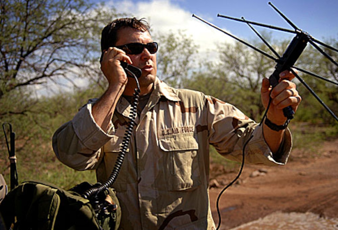 U.S. Air Force 2nd Lt. Daniel Goff, from the 58th Rescue Squadron, uses a PRC-117 radio to talk to an aircraft flying overhead during exercise Angel Thunder outside Davis-Monthan Air Force Base, Ariz., July 26, 2006.  