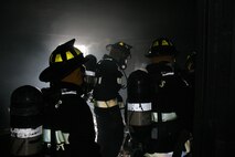 Trained firefighters, technichal rescue platoon, Chemical Biological Incident Response Force work their way through St. Louis Fire Departments tower. Navigating through smoke-filled rooms, the team demonstrates their faith in each other, and their confidence in the equipment they use to save lives. The team spent the day with St. Louis firefighters in a series of training situations, building trust and confidence in the interservice working relationship. The II Marine Expeditionary Force unit will need to work together successfully during a large-scale training exercise Aug. 9, with many other St. Louis-area emergency and crisis first responders