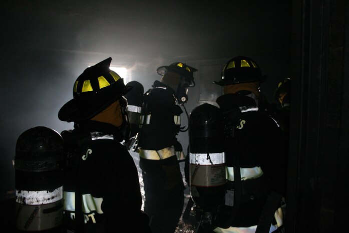 Trained firefighters, technichal rescue platoon, Chemical Biological Incident Response Force work their way through St. Louis Fire Departments tower. Navigating through smoke-filled rooms, the team demonstrates their faith in each other, and their confidence in the equipment they use to save lives. The team spent the day with St. Louis firefighters in a series of training situations, building trust and confidence in the interservice working relationship. The II Marine Expeditionary Force unit will need to work together successfully during a large-scale training exercise Aug. 9, with many other St. Louis-area emergency and crisis first responders