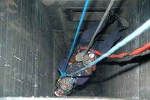 A St. Louis firefighter dangles from the rappel ropes, closely monitored by the II Marine Expeditionary Force Chemical Biological Incident Response Force technical rescue platoon, Aug. 8. CBIRF was in St. Louis to foster a working relationship and to train with the area's emergency first reponders.
