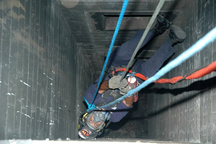A St. Louis firefighter dangles from the rappel ropes, closely monitored by the II Marine Expeditionary Force Chemical Biological Incident Response Force technical rescue platoon, Aug. 8. CBIRF was in St. Louis to foster a working relationship and to train with the area's emergency first reponders.