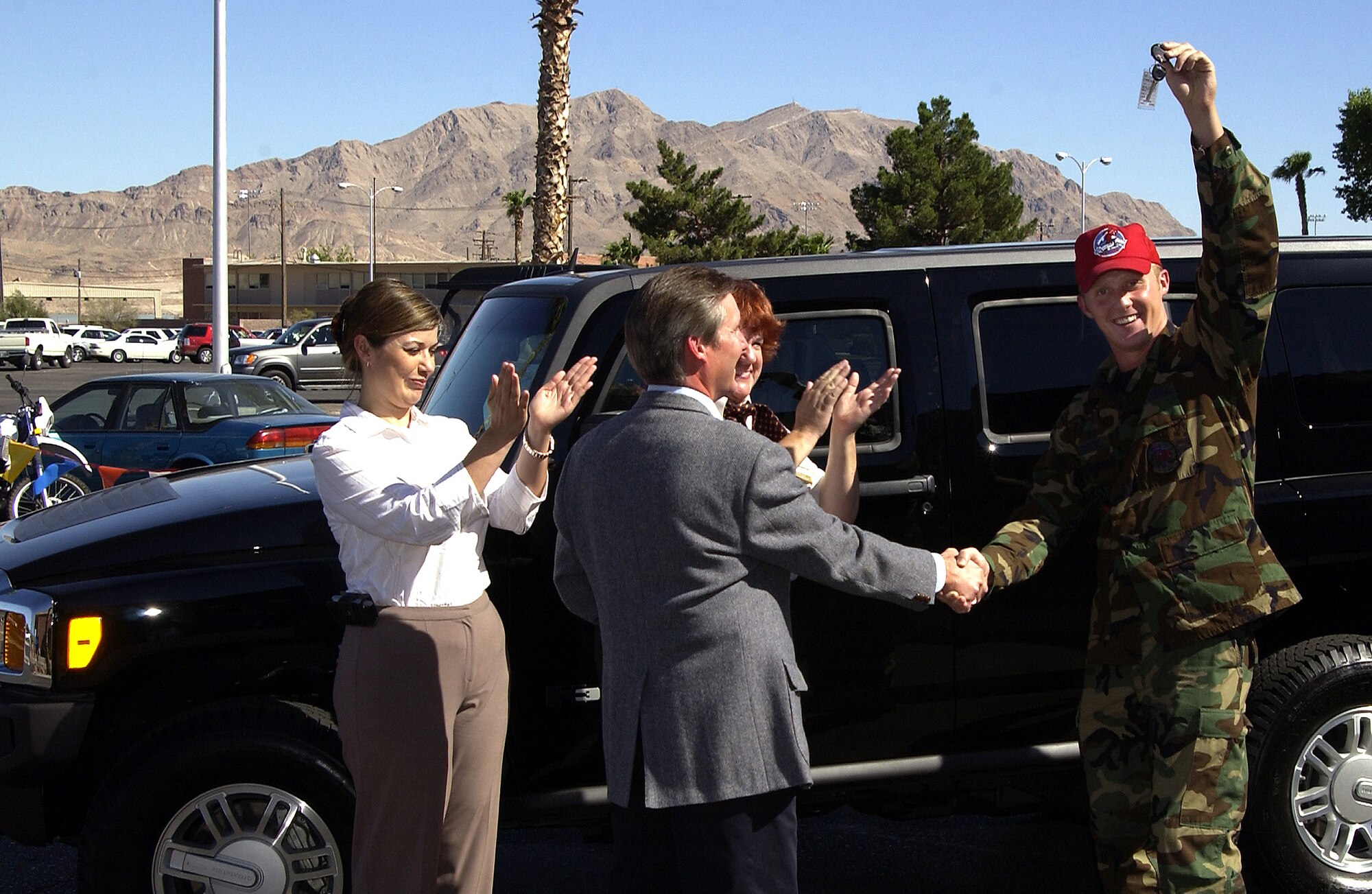 Senior Airman Daniel O'Conner, 820th RED HORSE Squadron, receives the keys to a brand new 2006 Hummer H3 Oct. 7 at Nellis Air Force Base, Nev.  Airman O'Conner won the H3 in Burger King's worldwide General Adventure Sweepstakes.  The contest was held in 202 Burger King stores on military installations in the U.S., the Pacific and Europe. The two other winners were in Japan and England.  RED HORSE is a highly mobile, self-sufficient combat construction unit capable of extended operations in a hostile environment. (U.S. Air Force photo/Airman 1st Class Jeffery Hall)                             