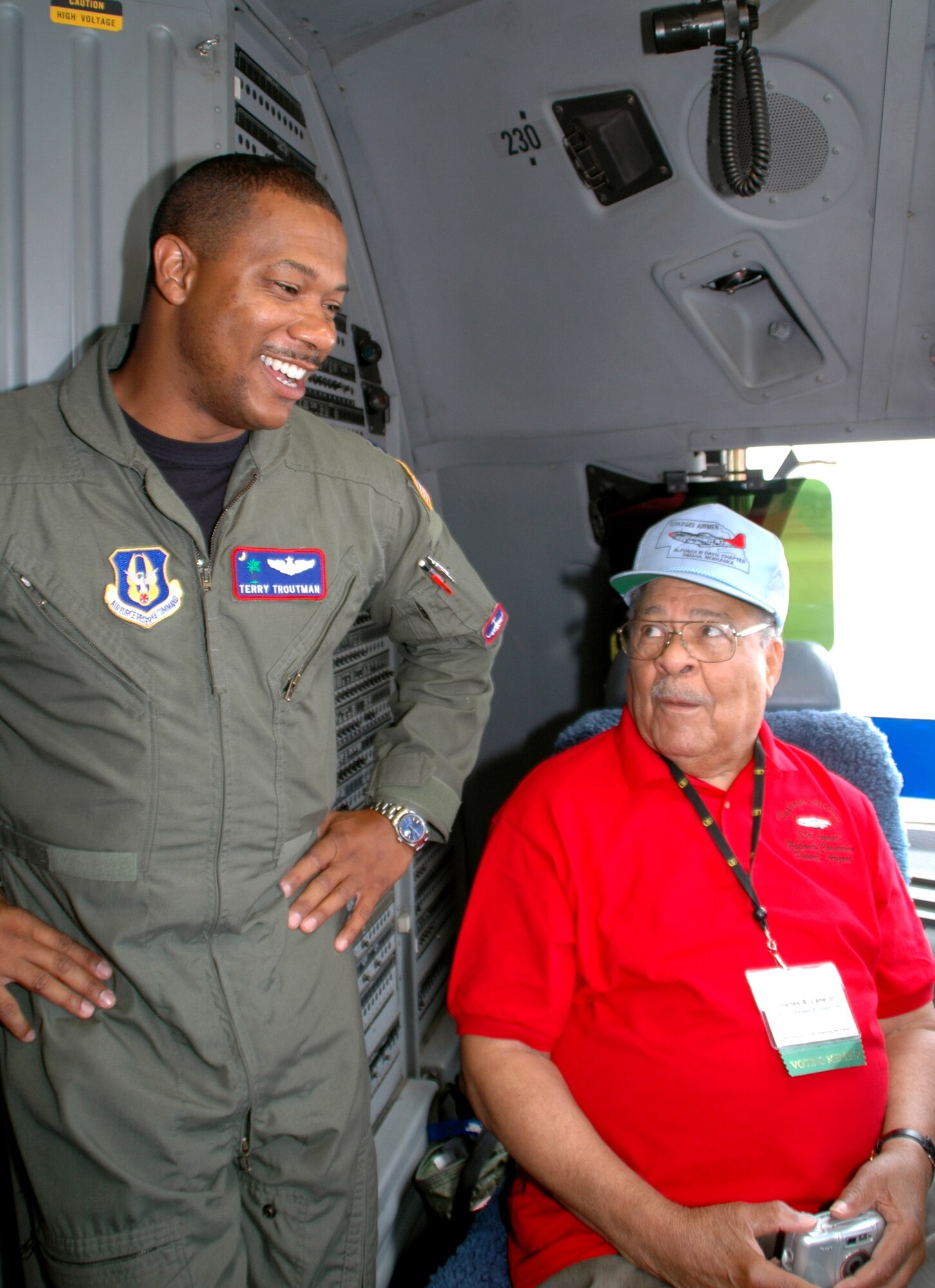 Capt. Terry Troutman talks with 81-year-old Charles Lane, an original Tuskegee Airman, as they sit in the flight deck of a C-17 Globemaster III prior to an orientation flight on Aug. 5. The original Tuskegee Airmen were given the orientation flight by an all black aircrew as part of the 2006 Tuskegee Airman Convention in Phoenix. Captain Troutman is a reservist assigned to the 701st Airlift Squadron at Charleston Air Force Base, S.C. (U.S. Air Force photo/Capt. Wayne Capps) 
