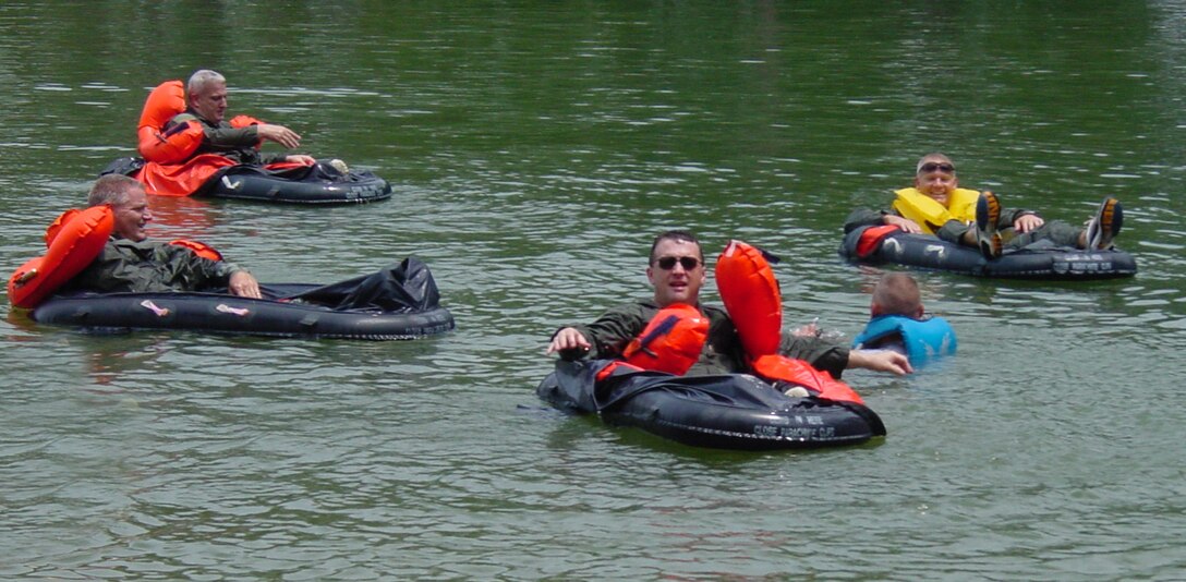 Life support technician Staff Sgt. Everett Jones instructs Tech. Sgt. Steve Wells (in dark sunglasses) and from left, Maj. Doran Gillie, Tech. Sgt. Scott Cathcart, and Lt. Col. John Stokes in the use of the single person life raft.  (U.S. Air Force Photo by Tech. Sgt. Joe Houston)