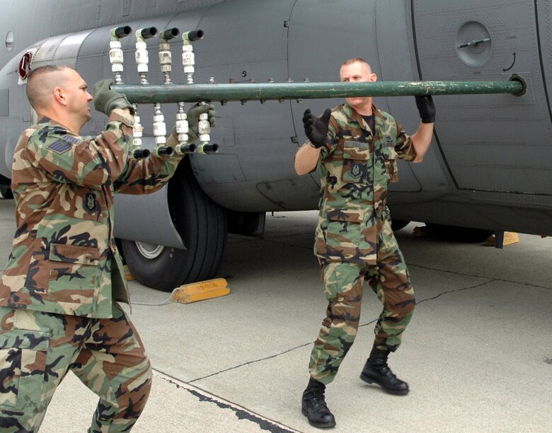 Tech. Sgts. Paul Tatar (left) and Tom Kocis prepare a boom nozzle configuration for a specially-modified C-130H Hercules at Moffett Federal Airfield, Calif., on Aug. 7 in support of the Safe Seas 2006 oil spill response exercise in San Francisco. The sergeants are aerial spray maintenance technicians with Air Force Reserve Command's 910th Airlift Wing at Youngstown Air Reserve Station, Ohio. (U.S. Air Force photo/Capt. Brent Davis)