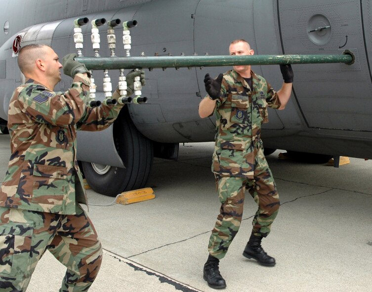 Tech. Sgts. Paul Tatar (left) and Tom Kocis prepare a boom nozzle configuration for a specially-modified C-130H Hercules at Moffett Federal Airfield, Calif., on Aug. 7 in support of the Safe Seas 2006 oil spill response exercise in San Francisco. The sergeants are aerial spray maintenance technicians with Air Force Reserve Command's 910th Airlift Wing at Youngstown Air Reserve Station, Ohio. (U.S. Air Force photo/Capt. Brent Davis)