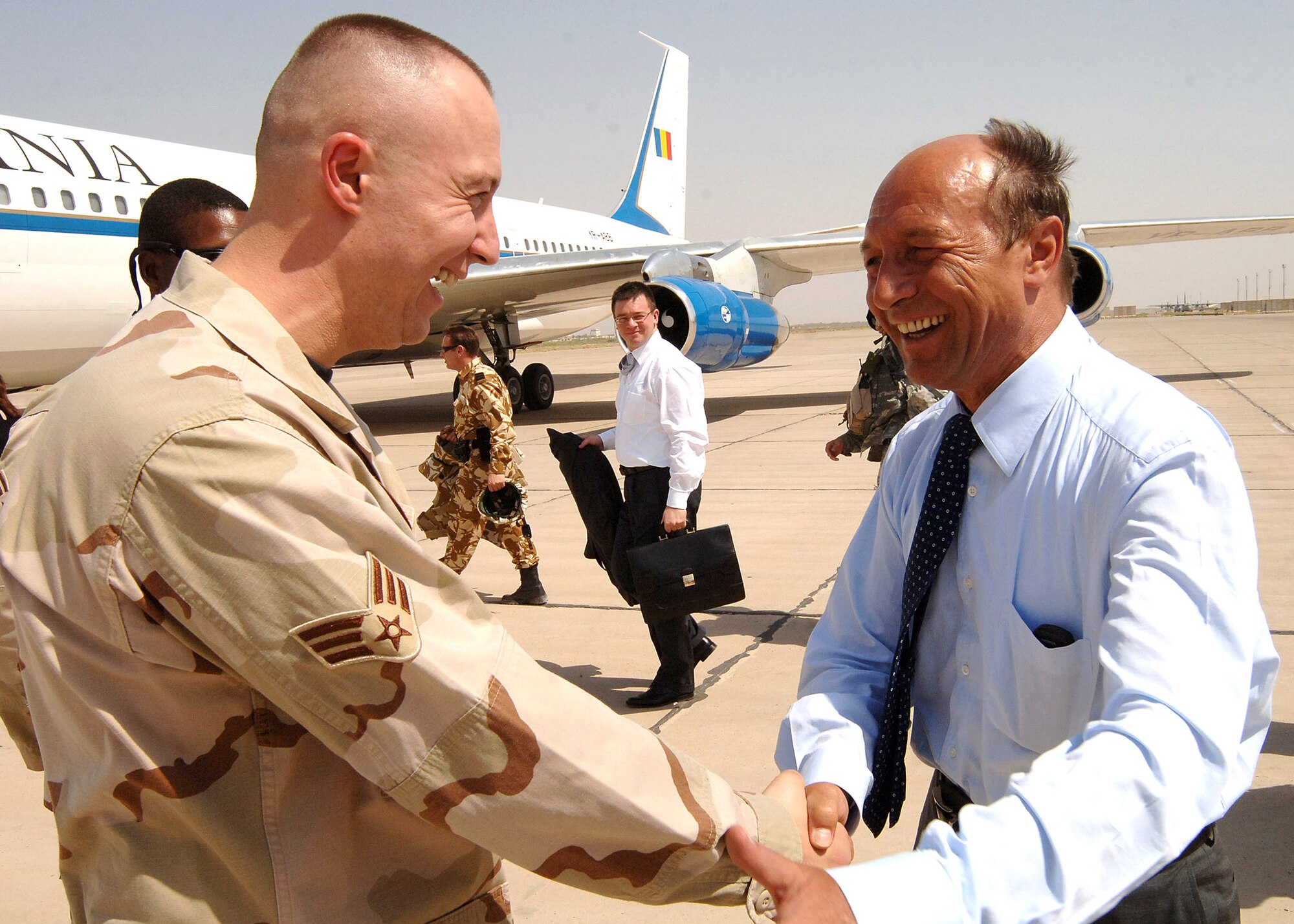Senior Airman Dan Visan shakes hands with Romanian president Traian Basescu during the president's visit to Baghdad Aug. 9. Airman Visan immigrated to the United States in 2000 from Timisoara, Romania, and was ecstatic to meet the Romanian president. Airman Visan is a force protection escort and has been able to use his bilingual abilities in his duties with third-country nationals at Sather Air Base, Iraq. He joined the Air Force in 2004 and is a dental technician at Scott Air Force Base, Ill. (U.S. Air Force photo/Staff Sgt. Bryan Bouchard)