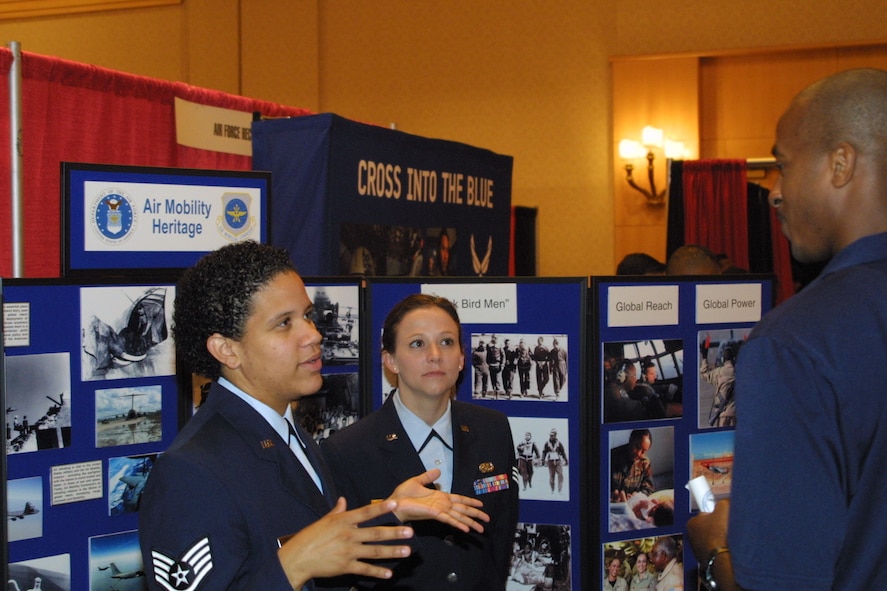 Staff Sgt. Kerri Harris, 9th Airlift Squadron, speaks to a member of the Civil Air Patrol about her experiences in Air Mobility Command as Senior Airman Shanna Tenney looks on. Both are from Dover AFB and attended the 35th Annual Tuskegee Airmen National Convention in Phoenix. 



