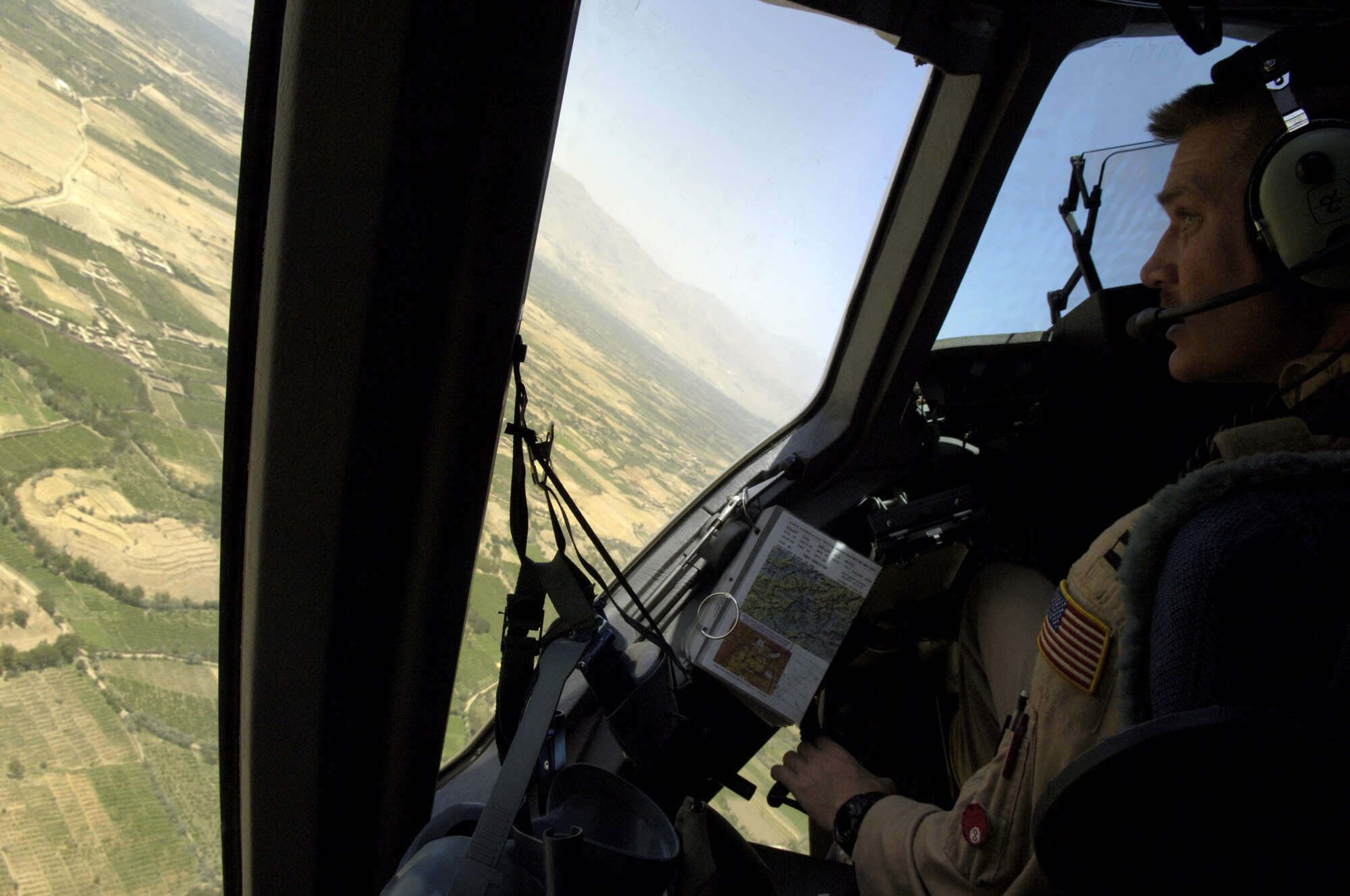 Capt. Nick Kreiser banks left over Bagram Air Base, Afghanistan, as his C-17 Globemaster III climbs to a safe altitude on Aug. 5. Captain Kreiser is a pilot with the 816th Expeditionary Airlift Squadron. The squadron flew more than 1,200 sorties in July, delivering cargo and troops in support of operations Iraqi Freedom and Enduring Freedom. (U.S. Air Force photo/Senior Airman Brian Ferguson)