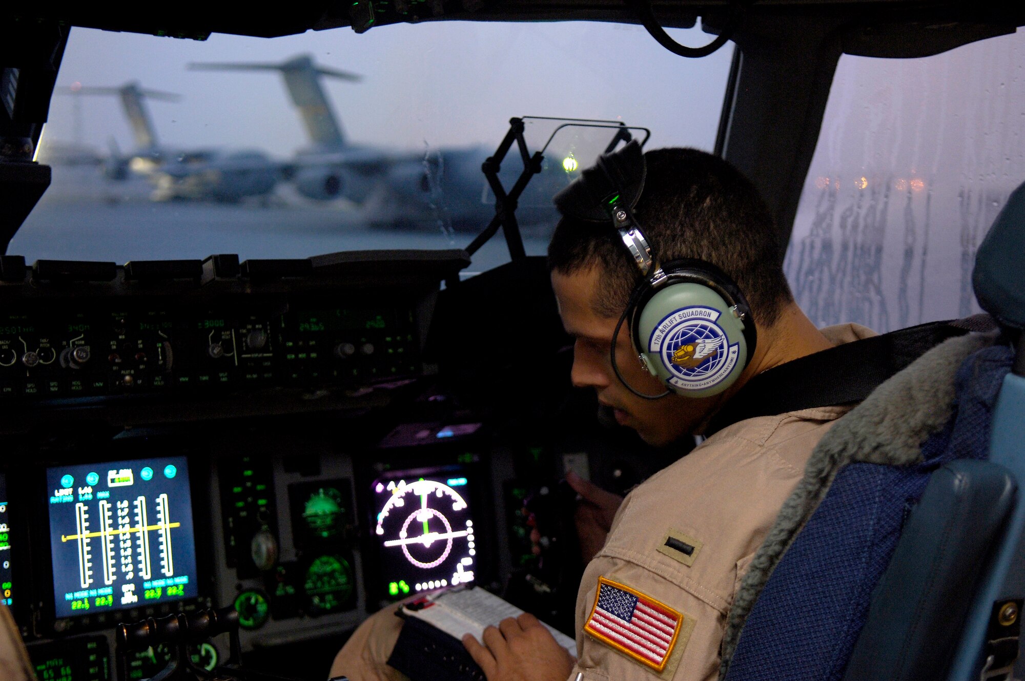 First Lt. Derek House prepares for takeoff from a forward operating base in Southwest Asia on Aug. 5. Lieutenant House is a C-17 Globemaster III pilot with the 816th Expeditionary Airlift Squadron. The squadron flew more than 1,200 sorties in July, delivering cargo and troops in support of operations Iraqi Freedom and Enduring Freedom. (U.S. Air Force photo/Senior Airman Brian Ferguson)