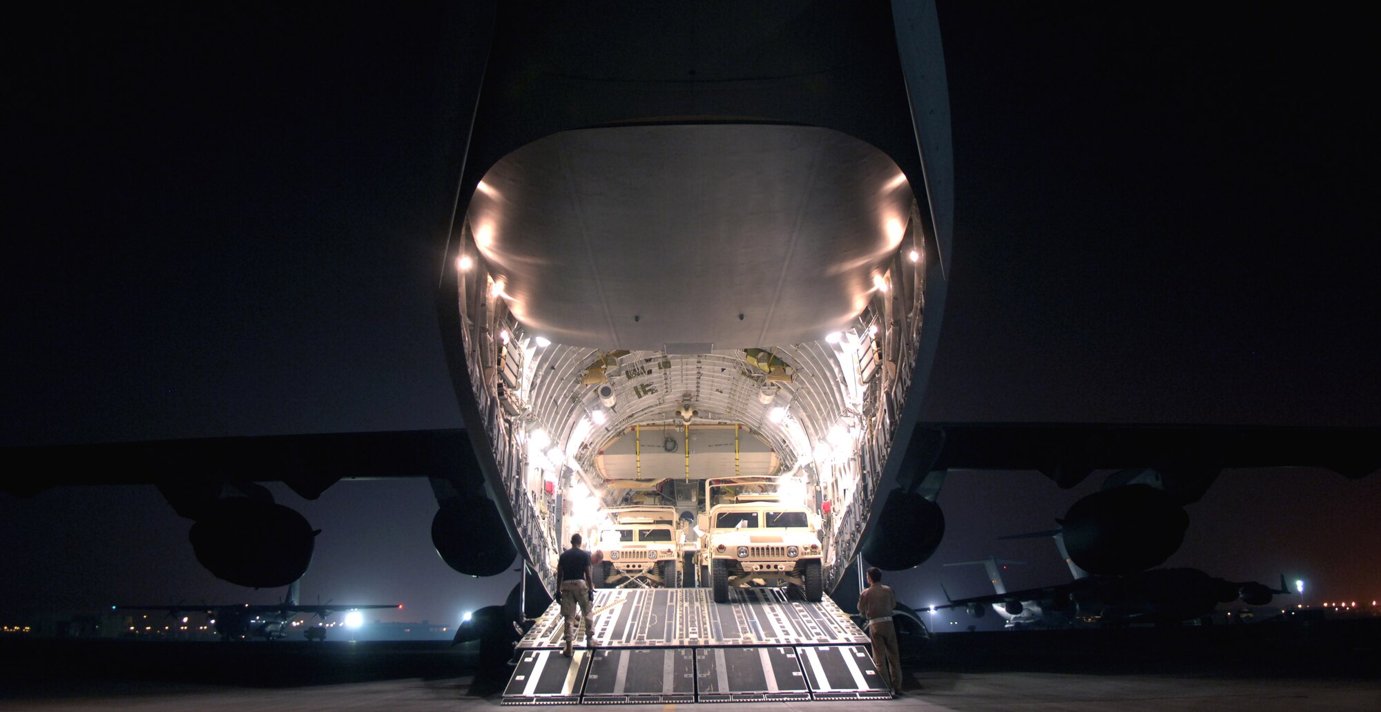 A C-17 Globemaster III is loaded with cargo at a forward operating base in Southwest Asia on Aug. 5. The C-17 is with the 816th Expeditionary Airlift Squadron. The squadron flew more than 1,200 sorties in July, delivering cargo and troops in support of operations Iraqi Freedom and Enduring Freedom. (U.S. Air Force photo/Senior Airman Brian Ferguson)
