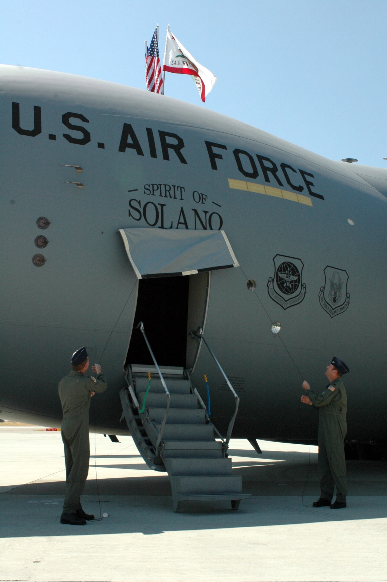Col. Steve Arquiette, 60th Air Mobility Wing commander, and Col. Robert Millmann, 349th AMW acting commander, unveil the "Spirit of Solano" C-17 Globemaster III at Travis Air Force Base, Calif., on Aug. 8. The "Spirit of Solano" is the first of 13 C-17s that Travis AFB will receive. (U.S. Air Force photo/Staff. Sgt. Matt McGovern) 

