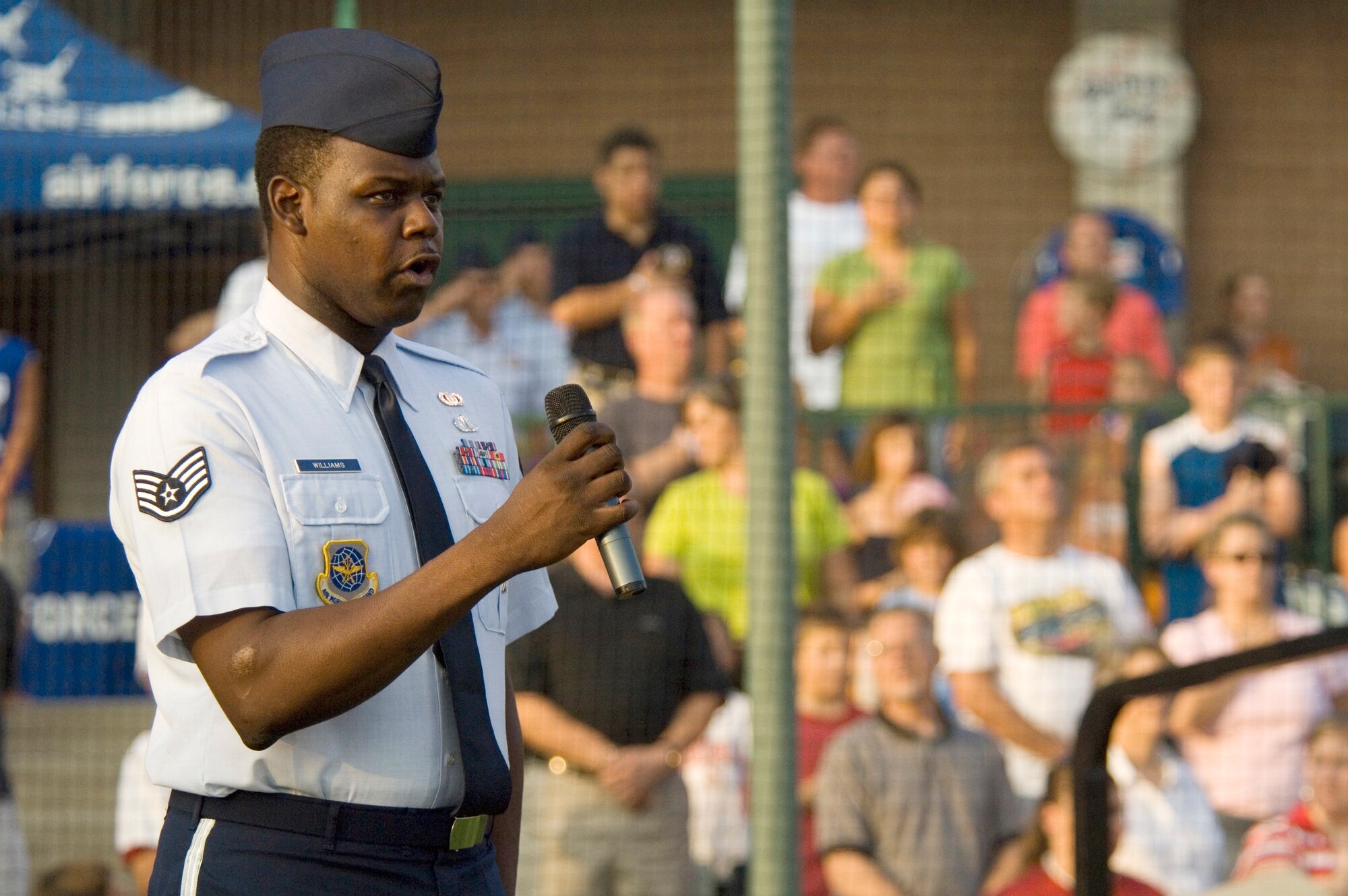 Staff Sgt. Albert Williams sings the national anthem before a Gateway Grizzlies minor league baseball game Aug. 8 in Sauget, Ill. Air Force night at the stadium featured special admissions and promotions for Airmen. The event was one of several activities taking place in the greater St. Louis area celebrating Air Force Week. Sergeant Williams is a member of the Air Force Band of Mid-America at Scott Air Force Base, Ill. (U.S. Air Force photo/Master Sgt. Jack Braden) 
