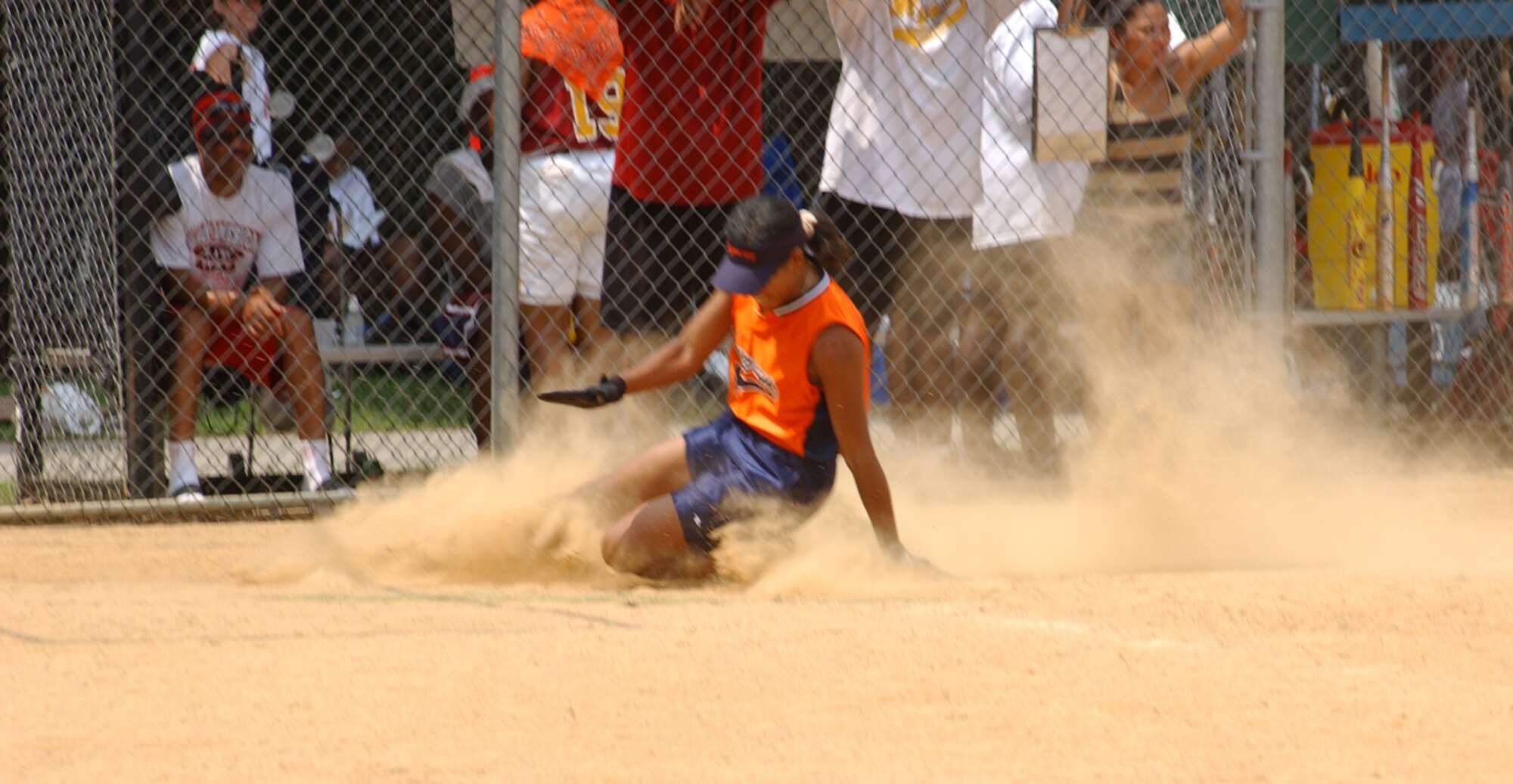 ANDREWS AIR FORCE BASE, Md. -- Tech. Sgt. Valerie Raynor, 459th Maintenance Group, slides home safely in a game against Fort Myer in NSA Military World Series Softball Tournament.  The 459th Air Refeuling Wing sponsored ladies softball team, Synergy, won this game and took third place in the world series.  The world series was held at Walter Reed Army Medical Center, Md.