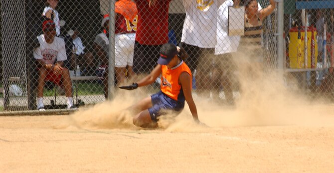 ANDREWS AIR FORCE BASE, Md. -- Tech. Sgt. Valerie Raynor, 459th Maintenance Group, slides home safely in a game against Fort Myer in NSA Military World Series Softball Tournament.  The 459th Air Refeuling Wing sponsored ladies softball team, Synergy, won this game and took third place in the world series.  The world series was held at Walter Reed Army Medical Center, Md.