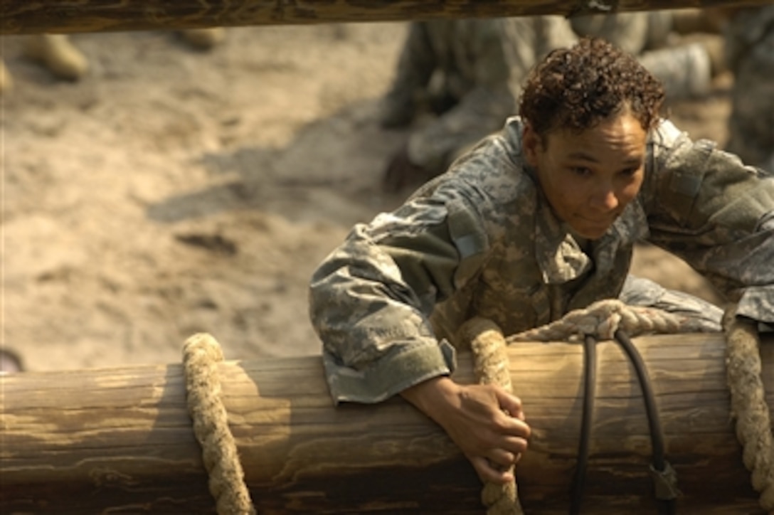 A U.S. Army soldier pulls her way to the top of the slide to victory obstacle during the confidence course phase of basic combat training at Fort Jackson, S.C., Aug. 8, 2006.  Basic combat training consists of nine weeks of training designed to hone skills and teach new skills as well as optimize physical and mental performance. 