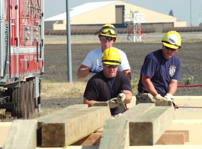 Senior Airman James Burks, 92nd Civil Engineer Squadron, and Staff Sgt. Robert Owens Jr., 92nd CES, learn to clear rubble in a collapsed building while Staff Sgt. Brandon Church, 92nd CES, looks on. The Fairchild firemen completed a 10-day urban search and rescue “train the trainer” course recently under the National Fire Protection Agency and Federal Emergency Management Agency training standards.