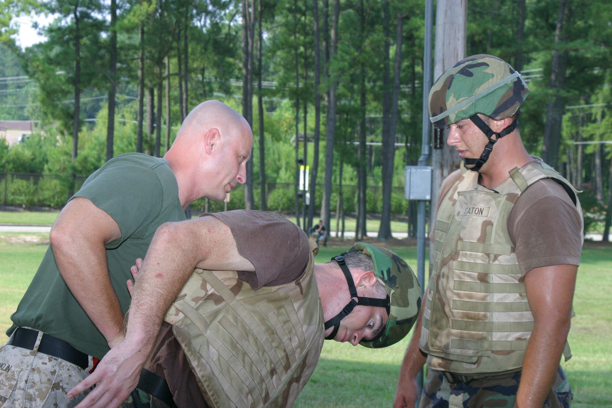 Master Gunnery Sgt. Shane Franklin, Martial Arts Center of Excellence instructor, performs a submission technique on Tech. Sgt. Russell Froat, 18th Weather Squadron combat weatherman, to Staff Sgt. Matt Staton, 18th Air Support Operations Group tactical air control party. Eighteen special operations Airmen from Pope participated in the 10-day close combat instruction course from Aug. 7 through today. Once they have completed the course, all will be certified instructors and tasked with teaching other Airmen in their own Air Force specialties. (U.S. Air Force photo/Senior Airman Stacia Zachary)