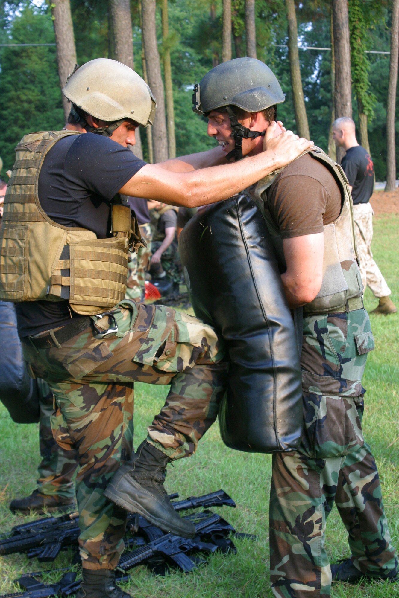 Senior Airman Louis Schnek, 14th Air Support Operations Squadron tactical air control party, performs a vertical knee strike while partner Airman 1st Class John Hughes, 682nd Air Support Operations Squadron TAC-P, during a close combat intructor course class. Eighteen special operations Airmen from Pope participated in the 10-day close combat instruction course from Aug. 7 through today. Once they have completed the course, all will be certified instructors and tasked with teaching other Airmen in their own Air Force specialties. (U.S. Air Force photo/Senior Airman Stacia Zachary)