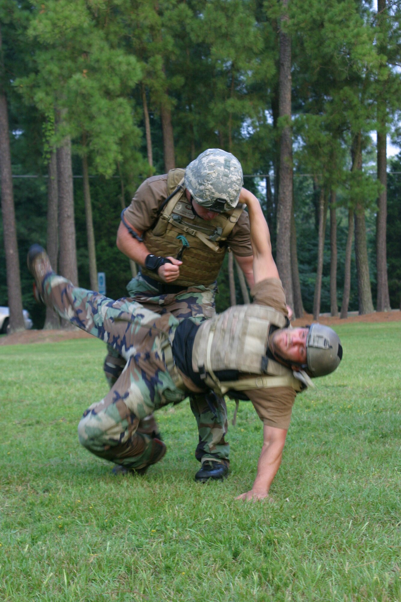 Senior Airman Adam Burns, 19th Air Support Operations  Squadron tactical air control party, performs a take down move on partner Staff. Sgt. Matt Green, 17th Air Support Operations Squadron TAC-P. Eighteen special operations Airmen from Pope participated in the 10-day close combat instruction course from Aug. 7 through today. Once they have completed the course, all will be certified instructors and tasked with teaching other Airmen in their own Air Force specialties. (U.S. Air Force photo/Senior Airman Stacia Zachary)