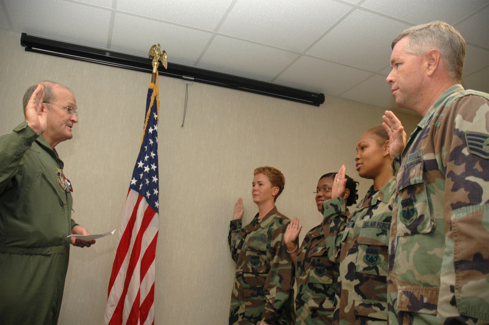 Four members from the 403rd Services Squadron, took an oath Aug. 6 to continue serving the Air Force Reserve and its troops. (Left) Brig. Gen. Rich Moss, commander, 403rd Wing, enlisted troops (right to left) Staff Sgt. Wayne Cox, Staff Sgt. Shakela Tashun Jackson, Staff Sgt. Coleen Patton, and Senior Master Sgt. Lisa Baldelli, NCOIC, Services.