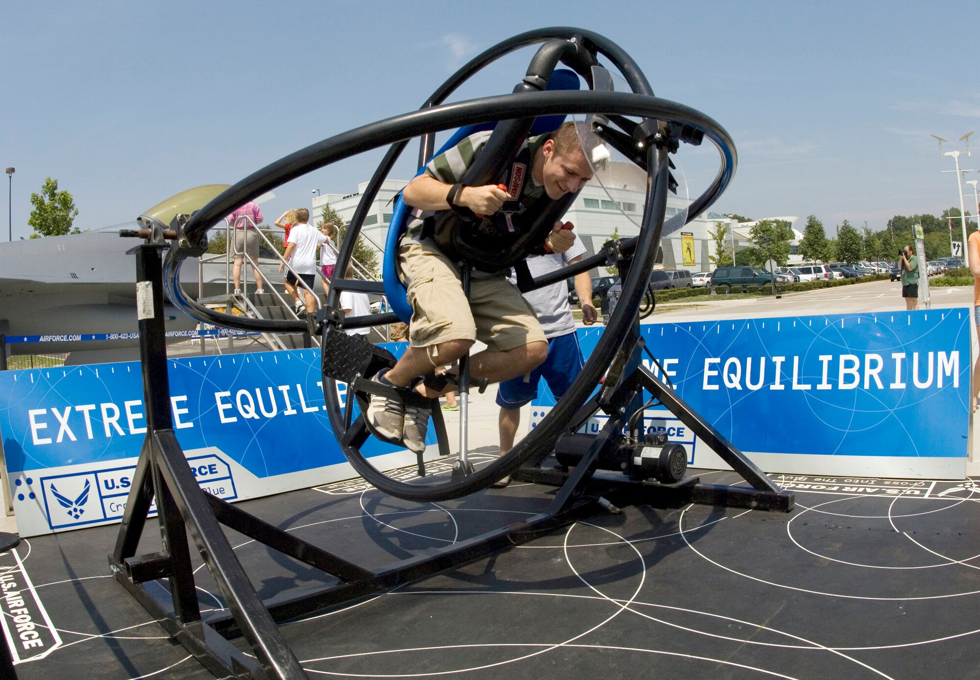 Chris Buzzetta, a senior at the University of Missouri at St. Louis, takes a spin on the Extreme Equilibrium machine Aug. 9 at the St Louis Science Center. The machine allows riders to experience some of the sensations that Air Force pilots feel when flying. Events at the center were some of several activities taking place in the greater St. Louis area celebrating Air Force Week. (U.S. Air Force photo/Master Sgt. Jack Braden)

