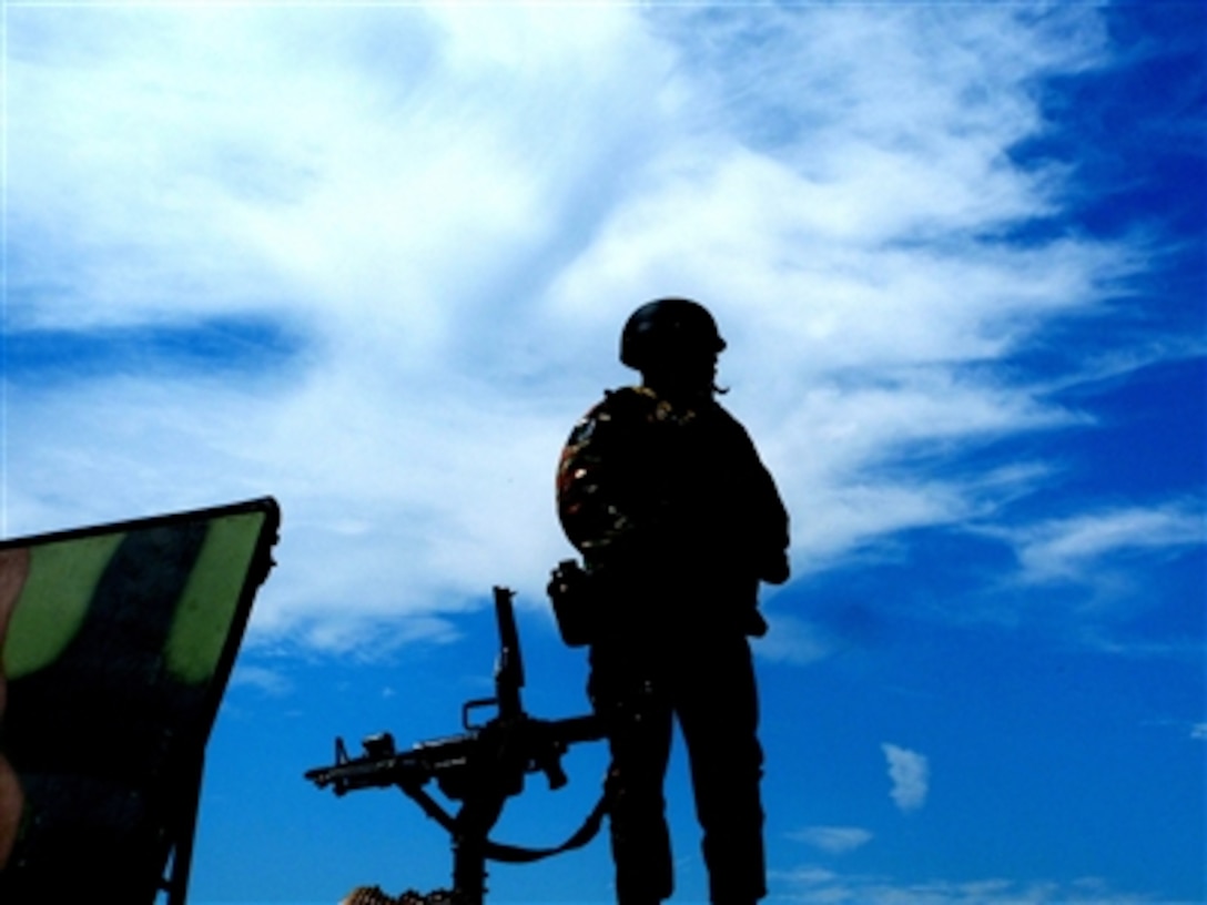 U.S. Air Force Staff Sgt. Shaylin Butler stands on top of a humvee during a break in training for convoy operations during the Phoenix Warrior Course 06-1 at Fort Dix, N.J., on Aug. 8, 2006.  Butler is an instructor for the 421st Combat Training Squadron. 