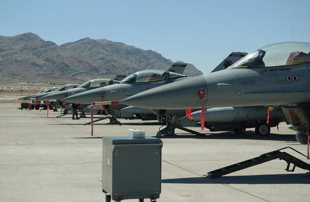 F-16 Fighting Falcons from the Air National Guard's 132nd Fighter Wing , Des Moines, Iowa, sit on the Nellis Air Force Base, Nev., flightline waiting for the night Red Flag launch on Aug. 8. Aircrews and maintainers from all U.S. services and several allied nations are taking part in Red Flag exercises, which prepare crews for  war in a highly realistic combat environment. (U. S. Air Force photo/Senior Airman Dan St. Pierre)