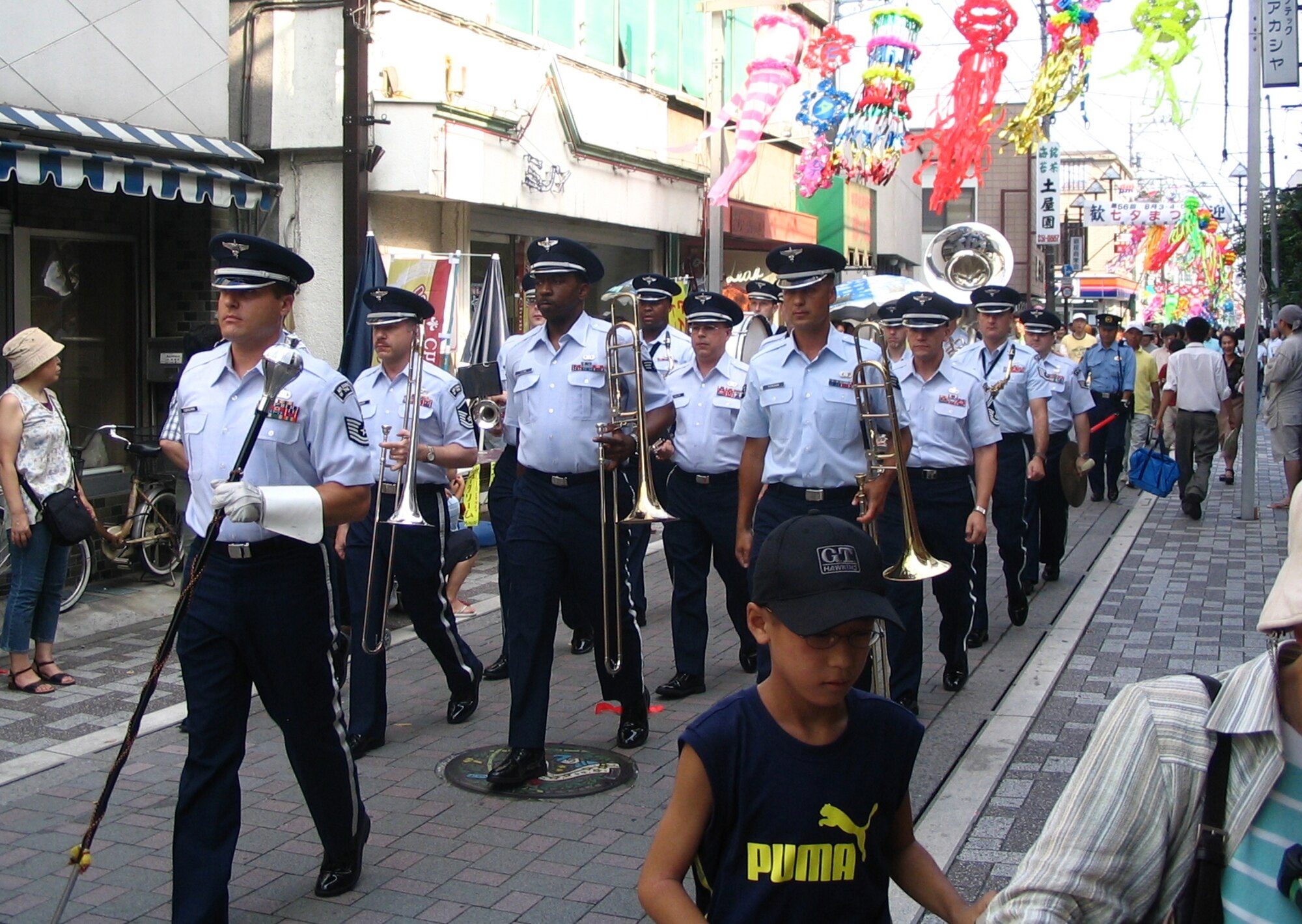 FUSSA-SHI, Japan -- The Pacific Air Forces band Pacific Trends marches through the streets of Fussa-shi, Japan, during The Tanabata Festival.  Tanabata, also known as the "star festival", takes place on the 7th day of the 7th month of the year, when, according to a Chinese legend, the two stars Altair and Vega, which are usually separated from each other by the milky way, are able to meet.  Pacific Trends performs at the annual Tanabata Festival in an act of friendship and continued community support.
