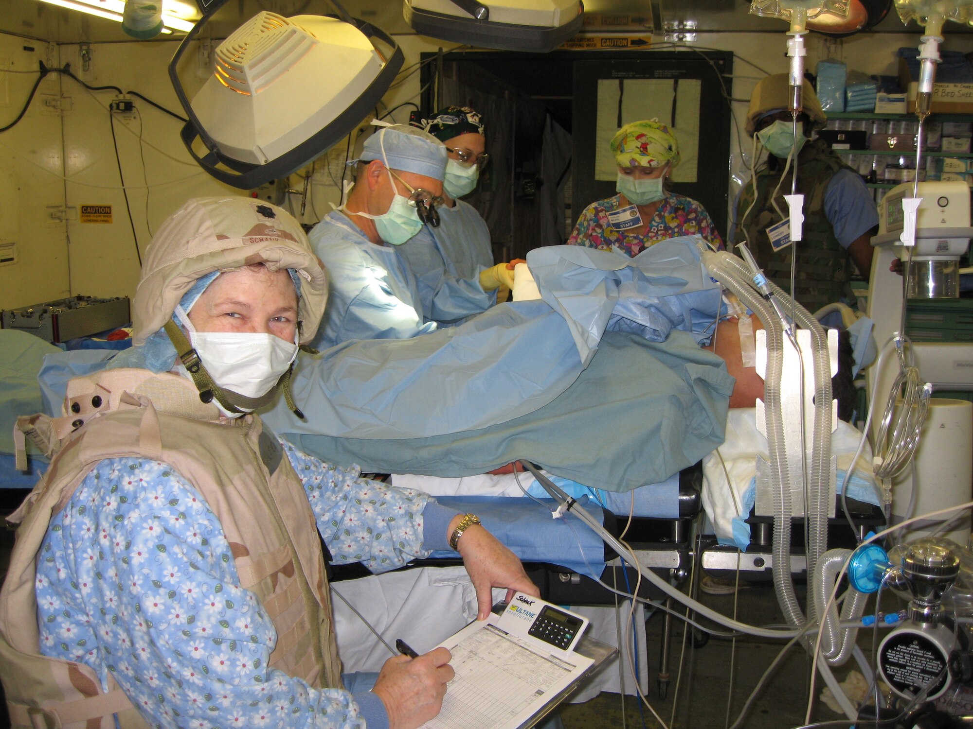 Lt. Col. Paulette Schank in operating room with body armor and helmet during a heighten state of readiness. Balad AB, Iraq is a target for insurgent mortar attacks.