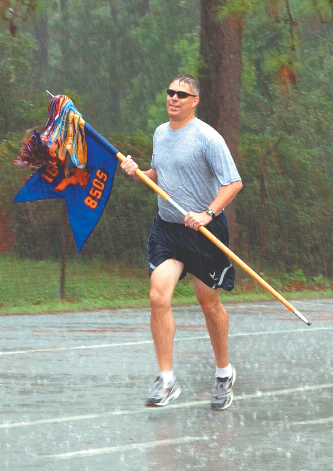 An Airman from the 8th Special Operations Squadron nears Hurlburt Field Aug. 9 with the unit's guidon. As part of the 8th SOS transition festivities, a team of Airmen ran the guidon 26 miles back to Hurlburt Field the same way it was delivered to Duke Field six years ago. (U.S. Air Force photograph by Senior Airman Andy Kin)