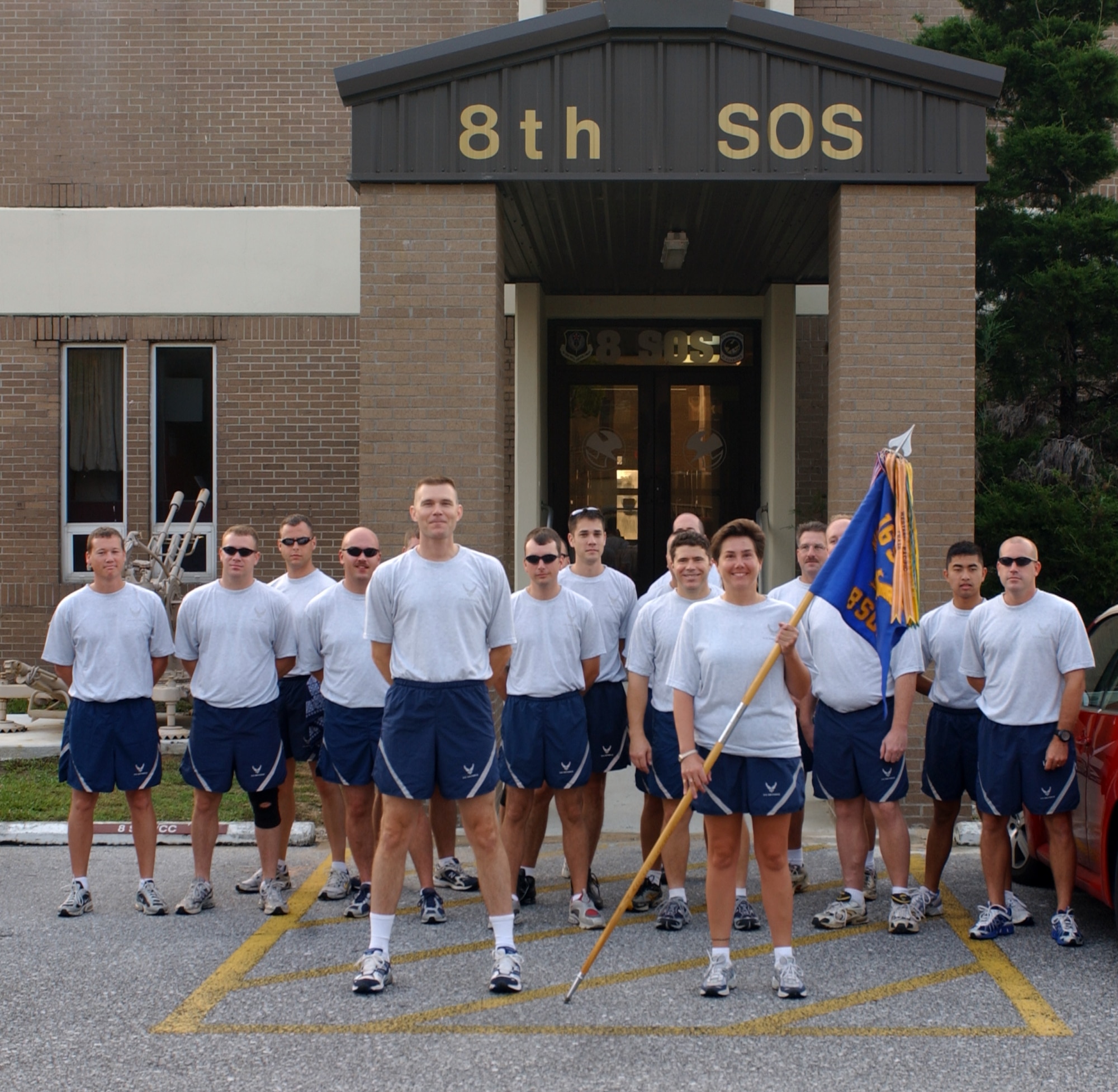 Members of the 8th Special Operations Squadron stand in front of their squadron at Duke Field, Fla., before participating in a 26-mile relay run from Duke Field to Hurlburt Field Aug 9. The run kicked off the start of the 8th SOS deactivation festivities prior to the official ceremony.  (U.S. Air Force photograph by Senior Airman Andy Kin)