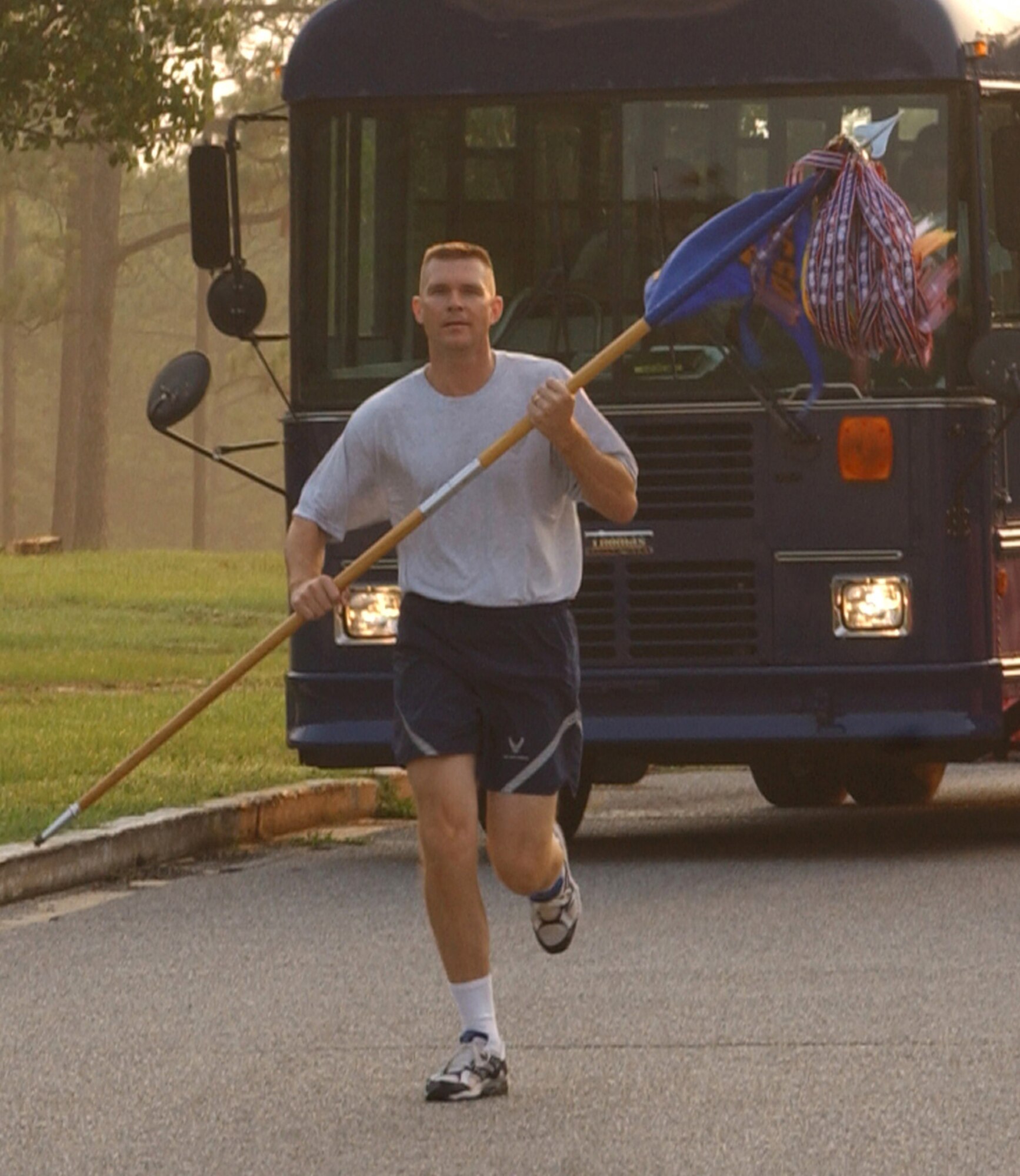 Lt. Col. Paul Caltagirone, 8th SOS director of operations, takes the squadron guidon on its first leg of the return home at Hurlburt Field, Fla. (U.S. Air Force photograph by Senior Airman Andy Kin)