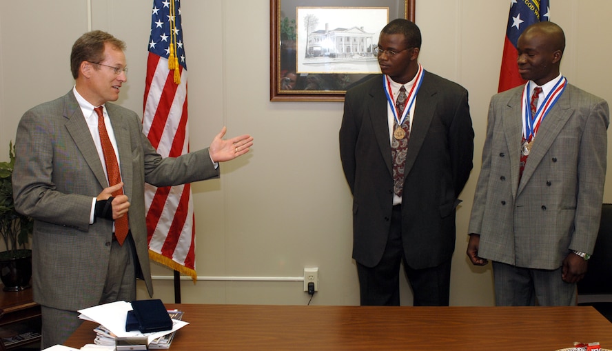 MOODY AIR FORCE BASE, Ga. -- Congressman Jack Kingston congratulates Dennis and Daniel Harris for their hard work during a Congressional Award ceremony recently. The brothers won the awards after dedicating many hours to volunteering and self-improvement. (courtesy photo)