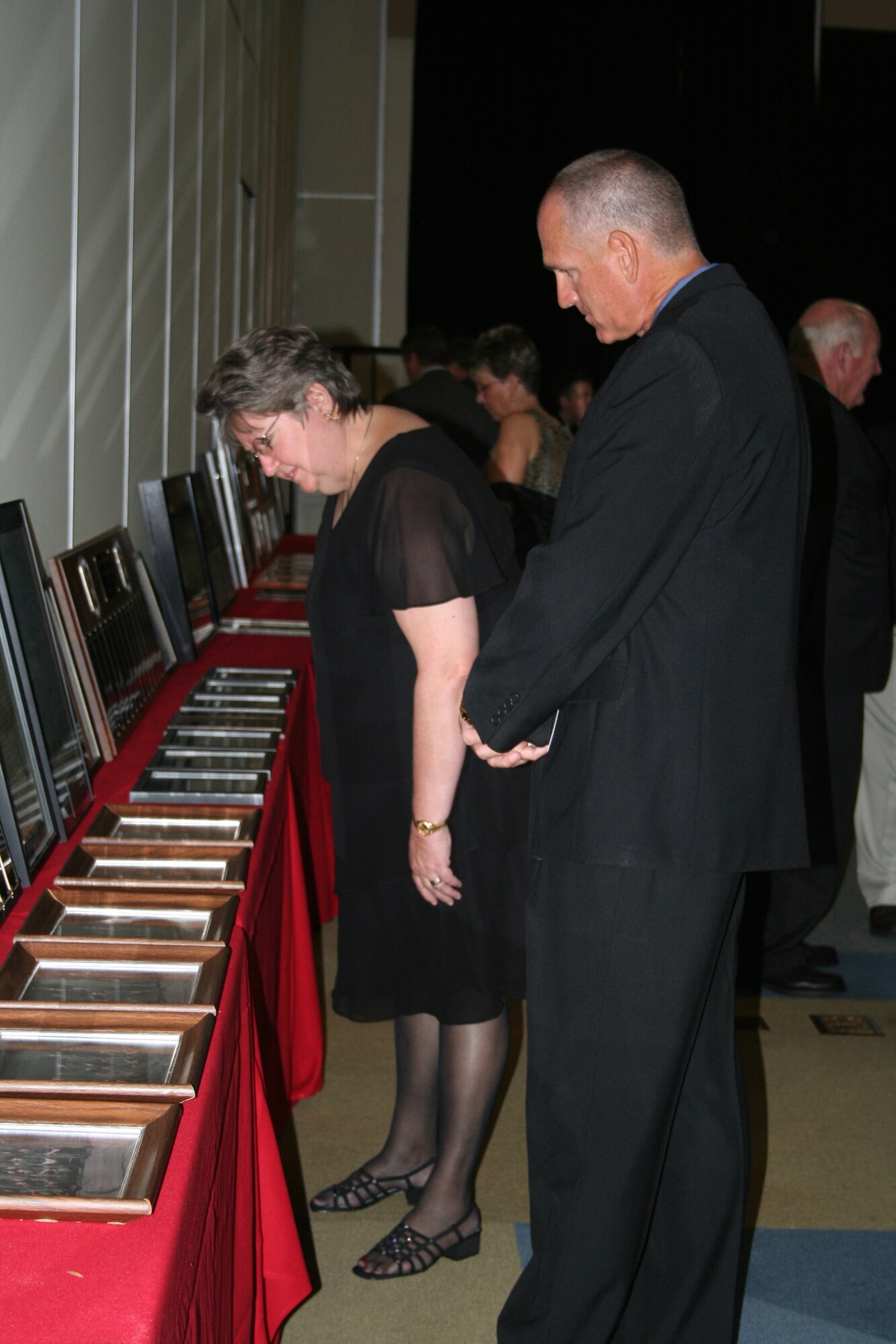 A couple observe a static display of 8th SOS memorabilia at the active-duty Combat Talon farewell dinner Aug. 9. (U.S. Air Force photograph by Staff Sgt. Mareshah Haynes)