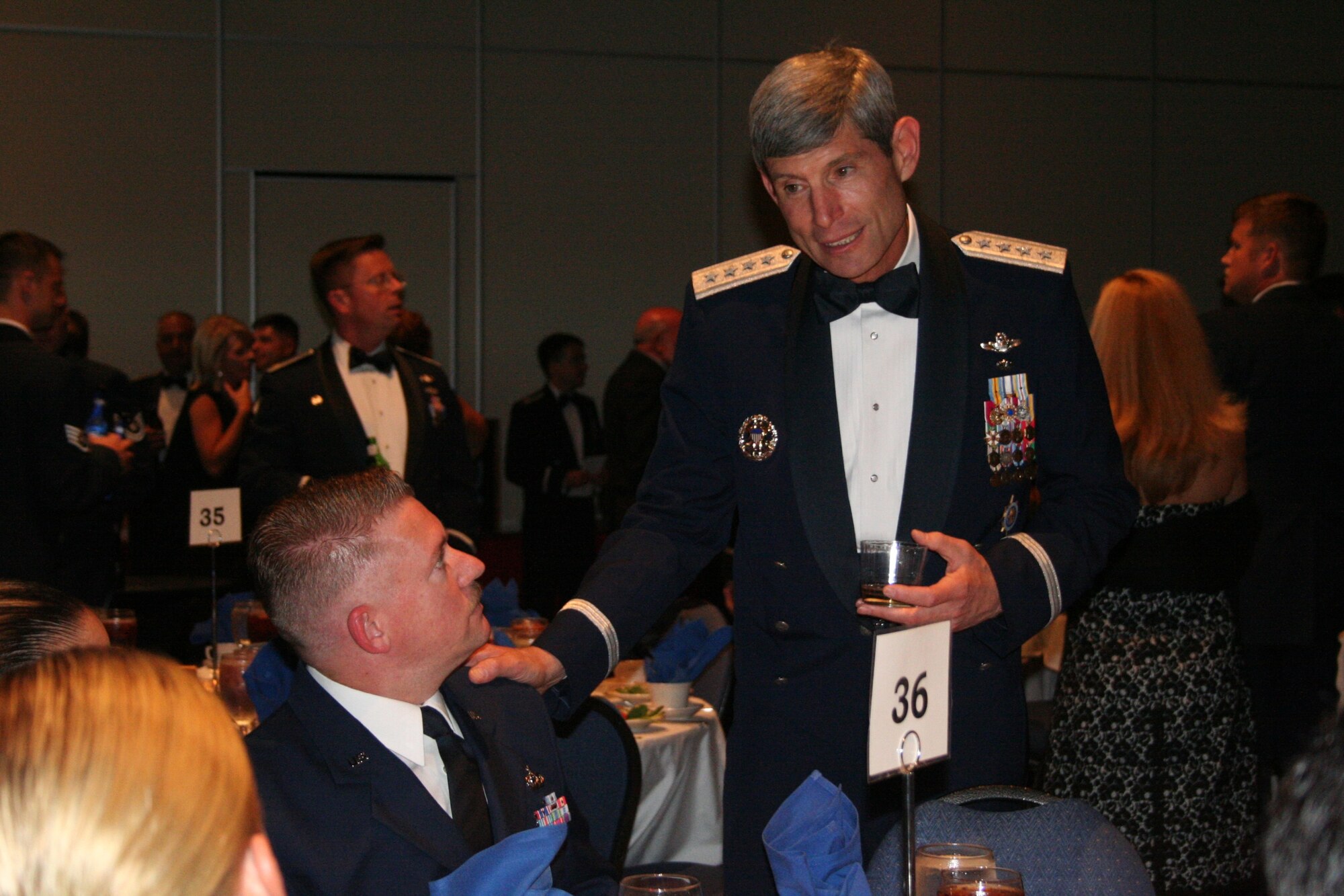 Gen. Norton Schwartz, U.S. Transportation Command commander, chats with members of the 8th Special Operations Squadron during social hour of the active-duty Combat Talon farewell dinner Aug. 9.  (U.S. Air Force photograph by Staff Sgt. Mareshah Haynes)