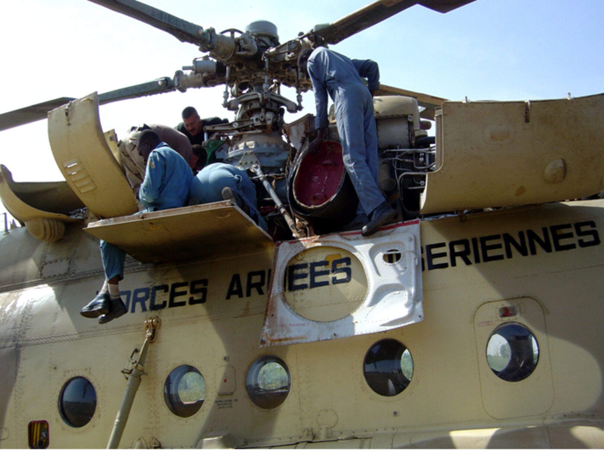 Advisors from the 6th Special Operations Squadron work with a Niger Mi-17 mission helicopter. (Courtesy photographs)