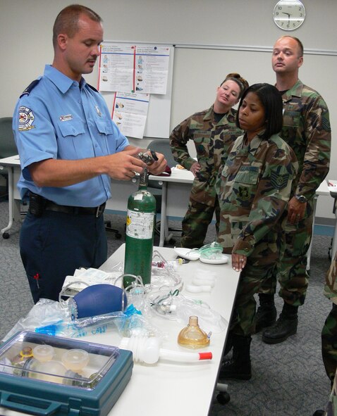 MOODY AIR FORCE BASE, Ga. -- Kevin Sullivan, student instructor and Fire Flight crew chief, shows emergency equipment operating procedures to students during the Emergency Medical Technician refresher course Tuesday. The course provided Moody EMTs updated emergency treatment information and incorporated several hands-on exercises. (US Air Force photo / Airman 1st Class Eric Schloeffel)  