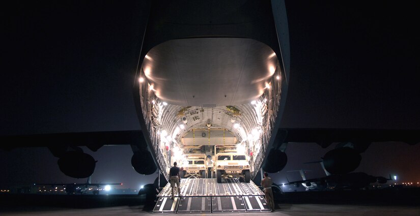 Humvees are loaded onto a C-17 Globemaster III at a forward operating base in Southwest Asia.  The C-17 is with the 816th Expeditionary Airlift Squadron. The squadron flew more than 1,200 sorties in July, delivering cargo and troops in support of operations Iraqi Freedom and Enduring Freedom. (U.S. Air Force photo/Senior Airman Brian Ferguson)
