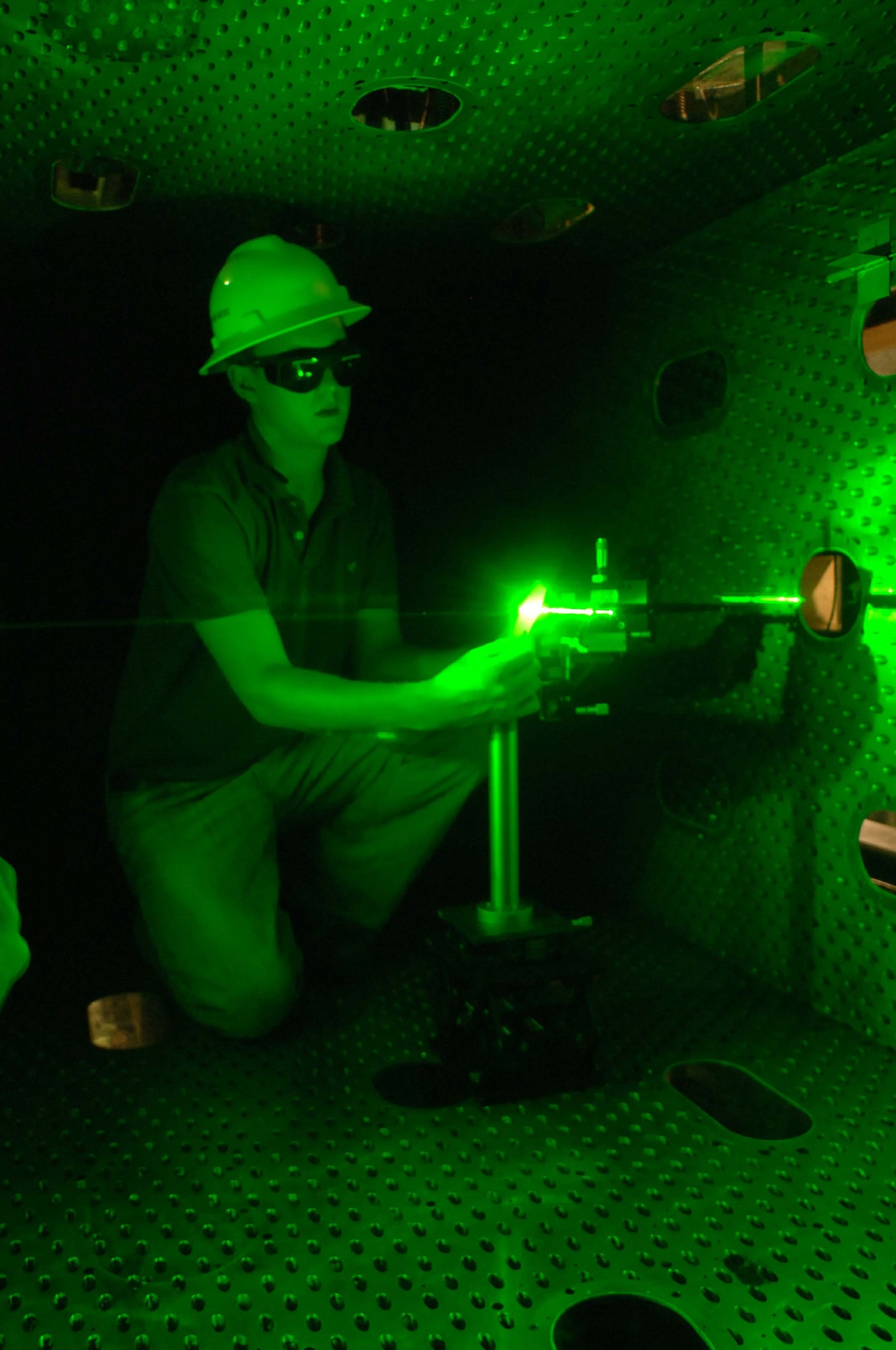 Nickolas Galyen, an engineer in Aerospace Testing Alliance’s Integrated Test and Evaluation department, aligns a calibration target during a series of tests to validate the use of stereo particle image velocimetry (PIV) in the 4-foot transonic wind tunnel at Arnold Engineering Development Center. Images of the precisely machined target are used to spatially calibrate particle images to measure three-dimensional velocity airflow fields. (Air Force photo by David Housch)
