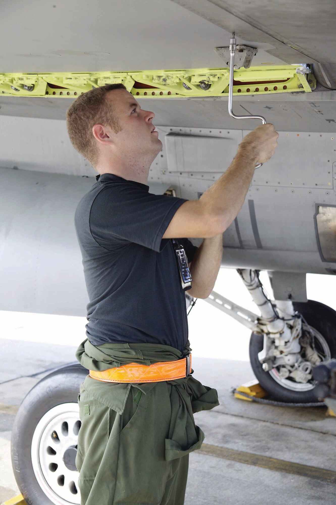 Senior Airman Adam Flood, 79th AMU crew chief, installs flaperon panels on the F-16 after a quality assurance inspection on his recent flaperon installation.  (U.S. Air Force photo/Senior Airman Holly MacDonald)