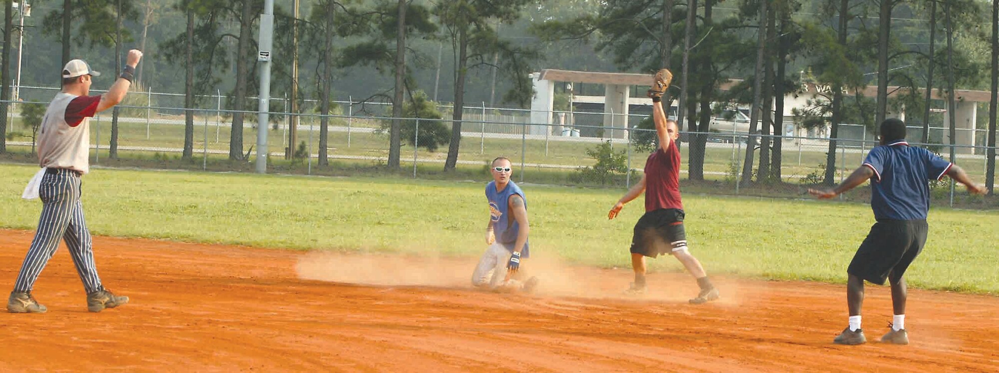 Senior Airman Craig Belden, 20th Security Forces Squadron, slides into second base for an extreme close call during the softball championship Aug. 3.  The umpire called Belden safe, while 20th Civil Engineer Squadron's pitcher, Senior Airman Jason Weaver, called Belden out.  (U.S. Air Force photo/Senior Airman John Gordinier)