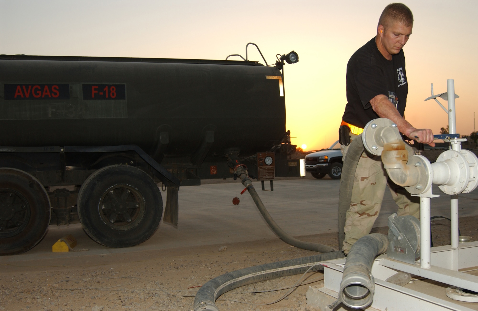 BALAD AIR BASE, Iraq -- Tech Sgt. Daniel Glore, 332nd Expeditionary Logistics Readiness Squadron, oversees the aviation gas system as it refills a fuel truck. The fuels flight of the 332nd ELRS pumps 12 million gallons of gas every four months. (U.S. Air Force photo/Senior Airman Kerry Solan-Johnson)                                             
