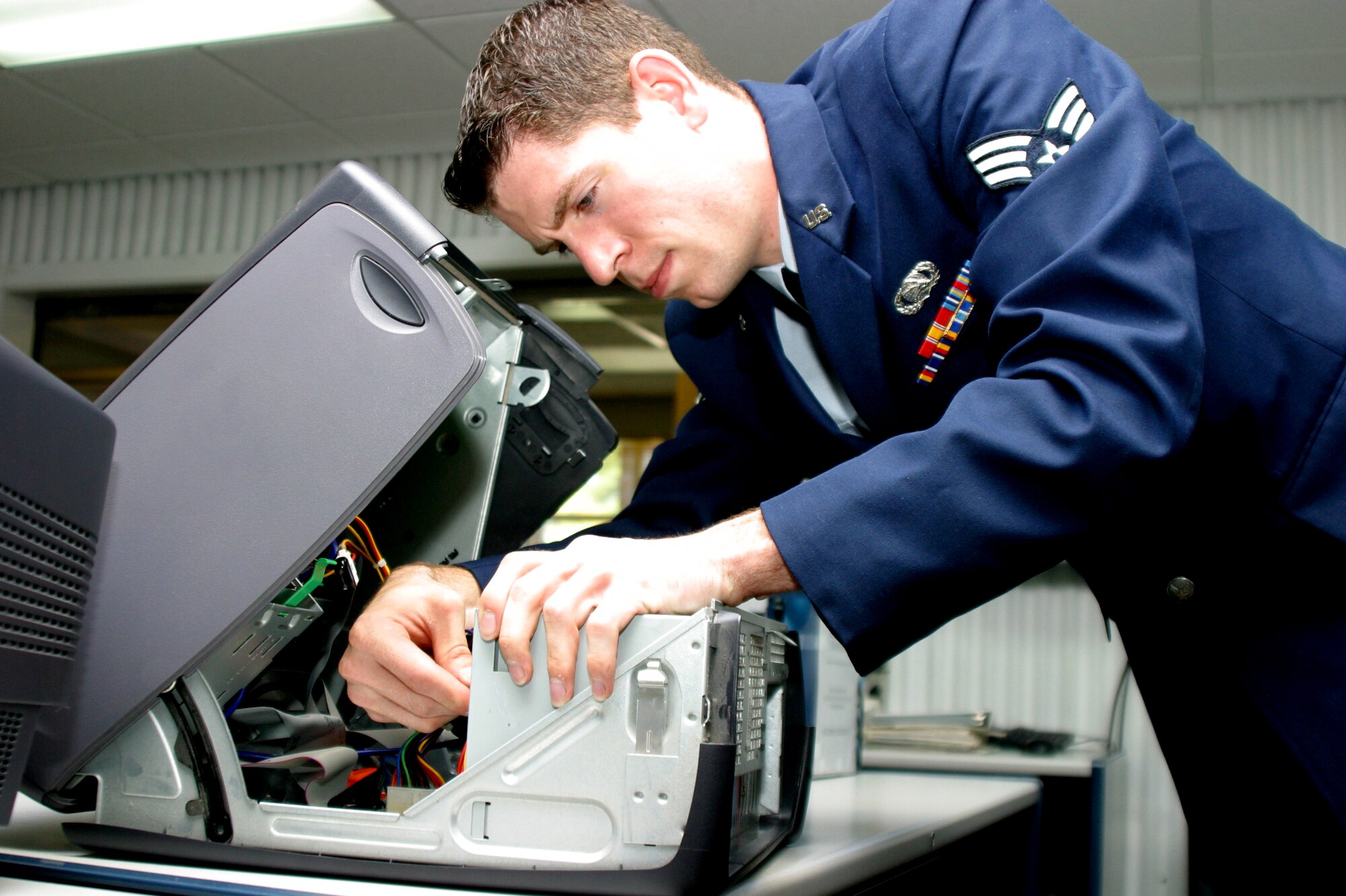Senior Airman Brian Quay, 43rd Communications Squadron Communications Computer Systems Controller, looks into a central processing unit to assess a techncal problem. Airman Quay also provides technical support for both classified and unclassified base wide network for the 43d Airlift Wing, 23d Fighter Group and 10 tenant units to better enable the free flow of information throughout Pope. (U.S. Air Force photo/ Senior Airman Stacia Zachary)