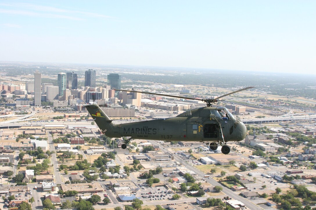 The Flying Memorial, Ugly Angel 'Yankee Lima 37,' a restored H-34 Sea Horse, approaches the downtown skyline of Fort Worth, Texas, during the 3rd Annual Cowtown Warbird Roundup held at Meacham Airport Aug. 11 and 12, an event that benefited the OV-10 Bronco Association, Forward Air Controller's Museum and the Vintage Flying Museum. Photo by Sgt. Joshua A. Tate
